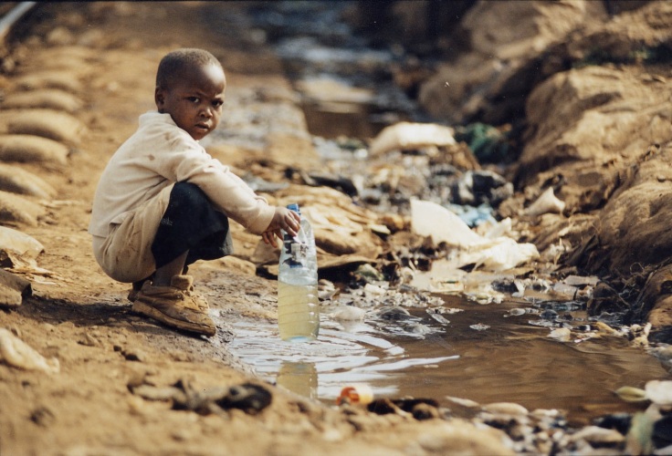 Young boy in Kenya collected unsafe drinking water from contaminated water source