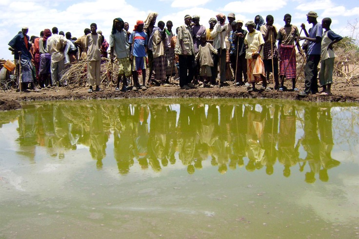 Residents gather to collect water at a contaminated reservoir in Dafed village in southern Somalias's Lower Shabelle region during a cholera outbreak